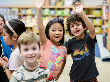 Students smiling together. Links to Gifts of Appreciated Securities